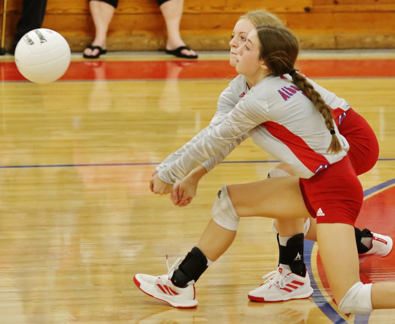 Alba-Golden’s backline, Cacie Lennon and Kamrin Wright, moves in for a dig against Cumby last Friday.
